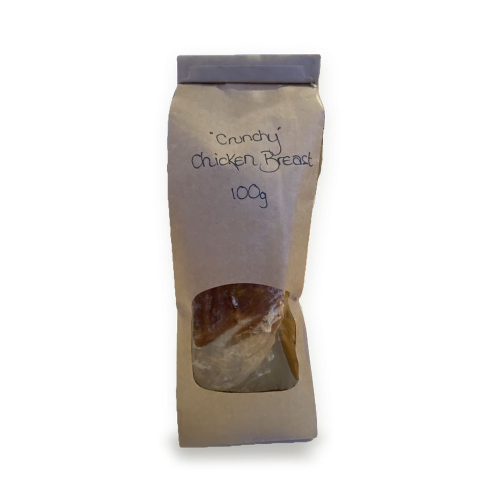 A hand-labelled kraft bag of crunchy chicken breast treats, 100g