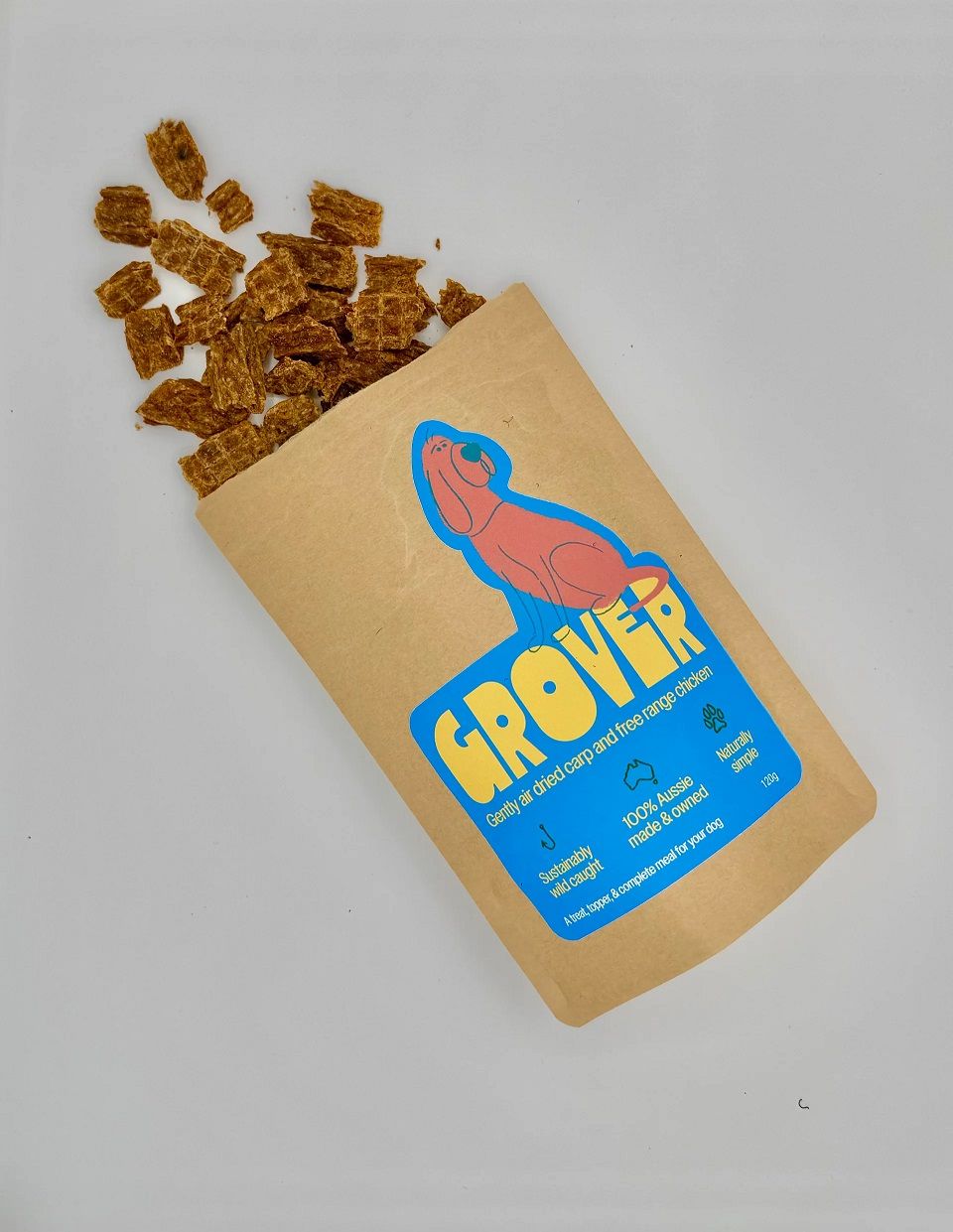 A pouch of Grover air-dried treats spilling onto the table