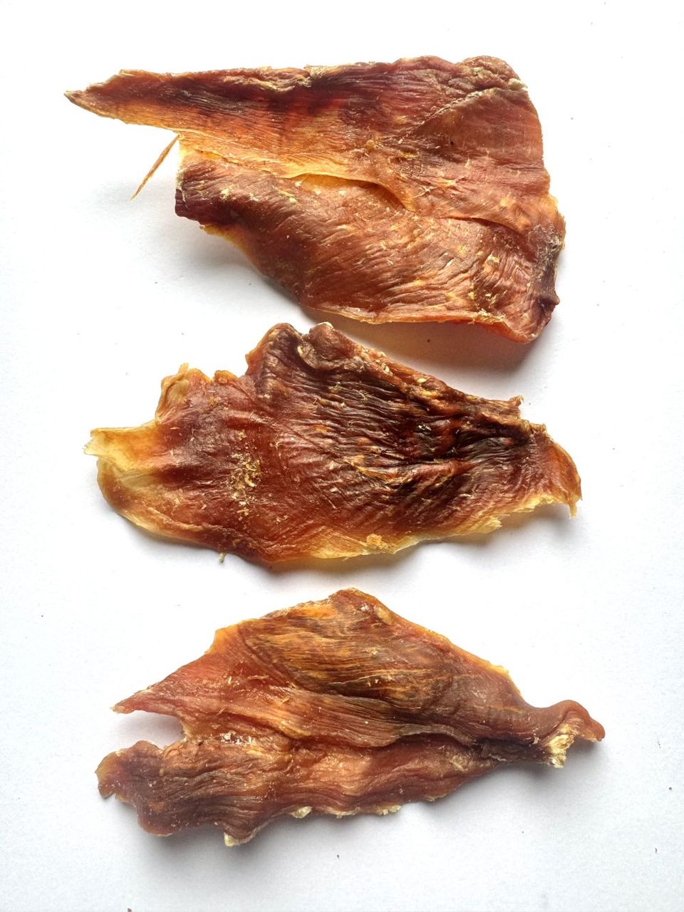 Three pieces of natural turkey jerky dog treats