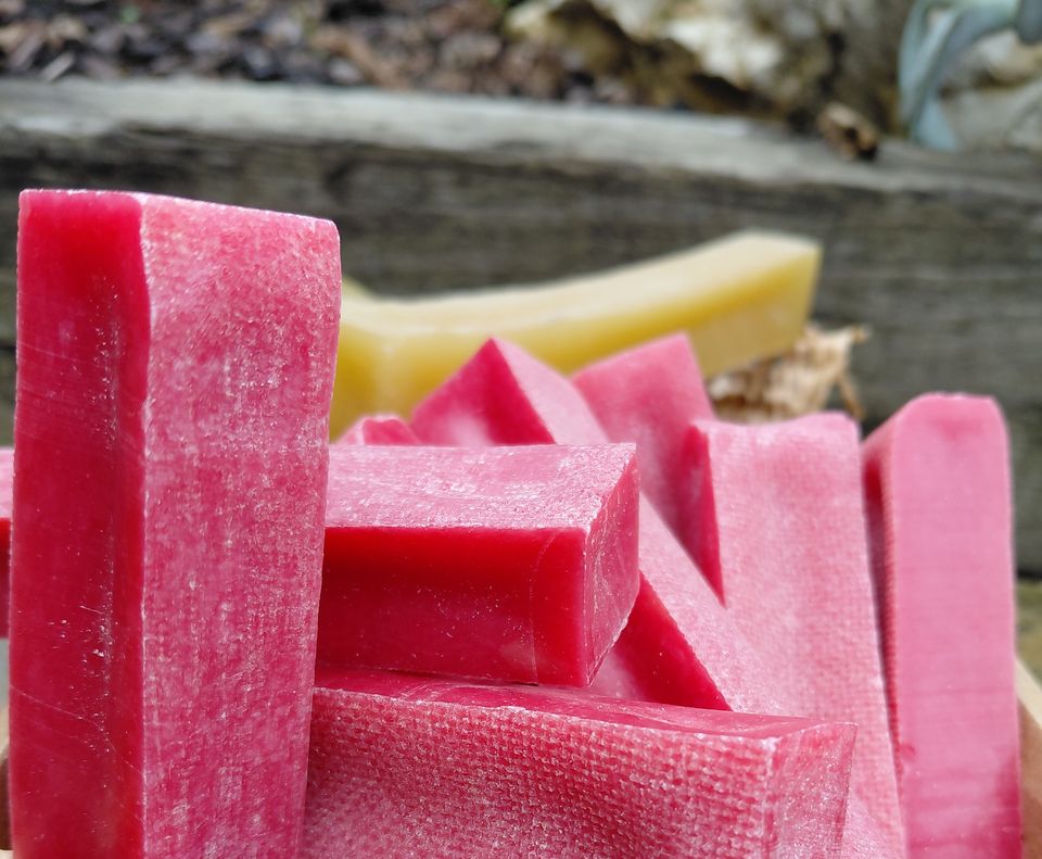 A crate of pink raspberry and natural yak chews on display